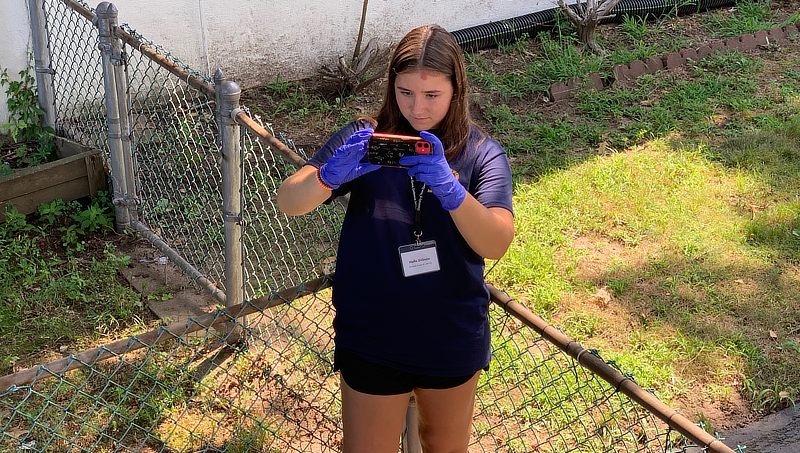 Halle DiGioia documents the exterior of the crime scene house.