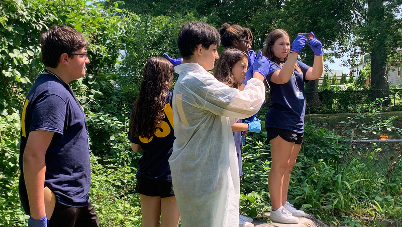 Student investigators photograph the crime scene house.